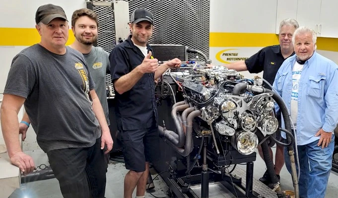 Team working on classic car engine 