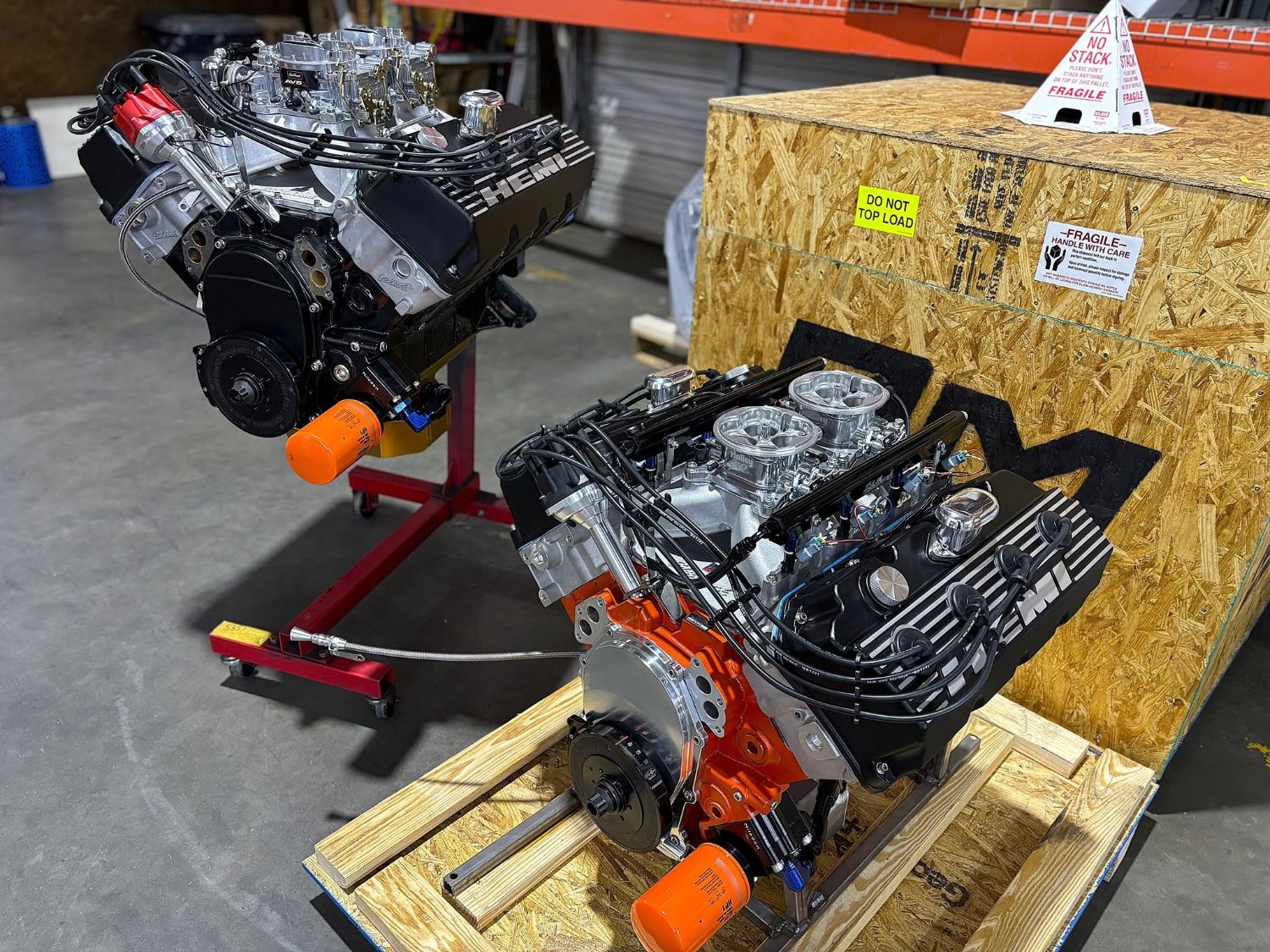 Two Hemi engines side by side, one with dual carburetors and one with electronic fuel injection